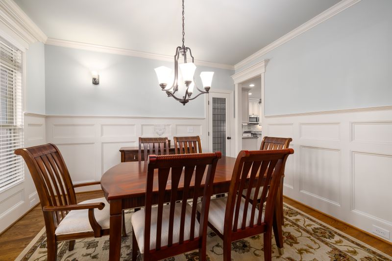 Dining room with classic white wainscoting and paneled walls